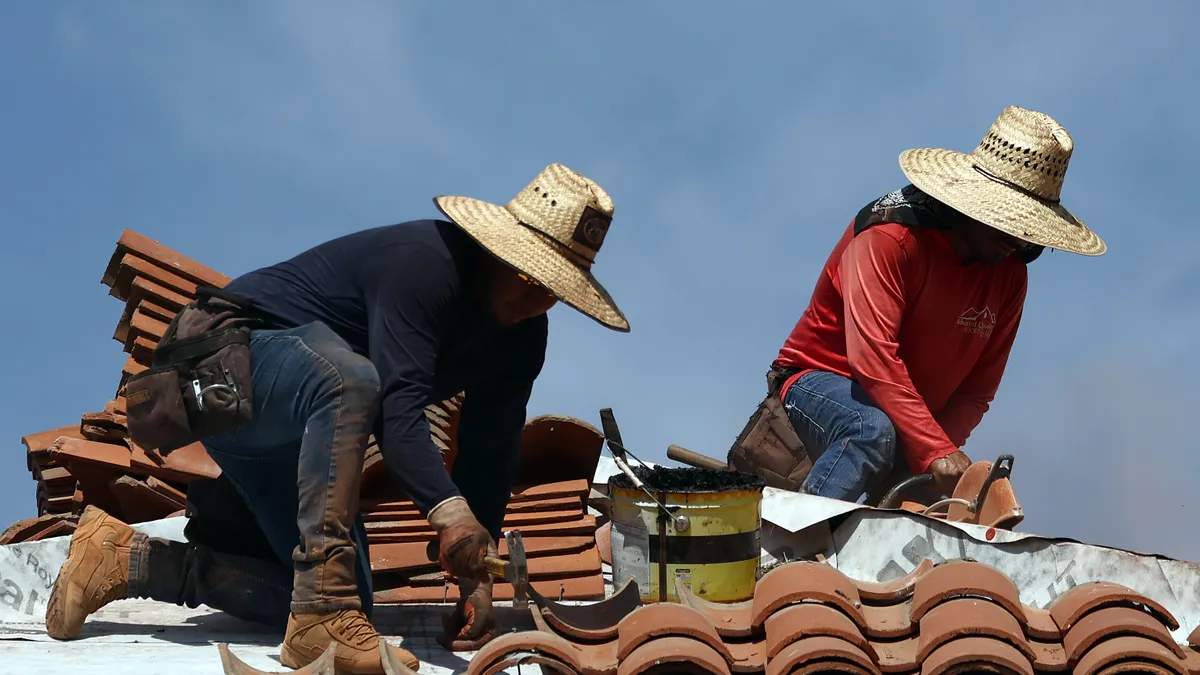 Workers on a roof on a sunny day.