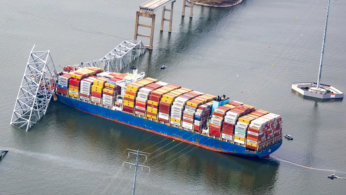 In an aerial view, the cargo ship Dali sits in the water after running into and collapsing the Francis Scott Key Bridge on March 26, 2024 in Baltimore, Maryland.